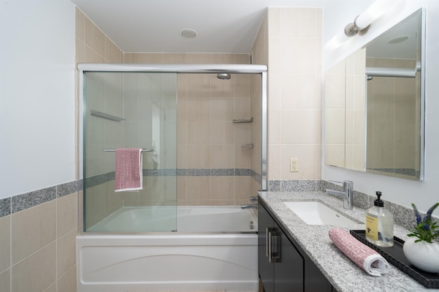1 Shore Ln Unit 1208, Jersey City, NJ 07310 - bathroom with tile walls, vanity, and shower / bath combination with glass door
