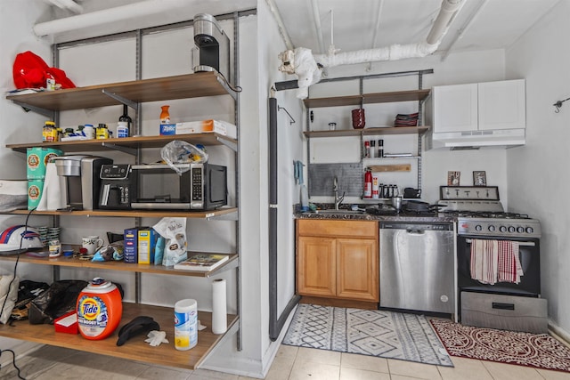 2615 John F Kennedy Blvd Unit B2, Jersey City, NJ 07306 - kitchen with stainless steel appliances, open shelves, under cabinet range hood, dark stone countertops, and light tile patterned floors