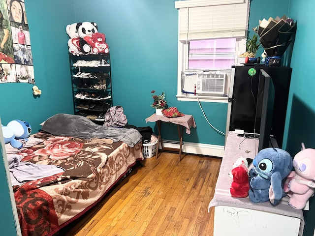 304 51st St, West New York, NJ 07093 - bedroom with a baseboard radiator, wood-type flooring, and cooling unit