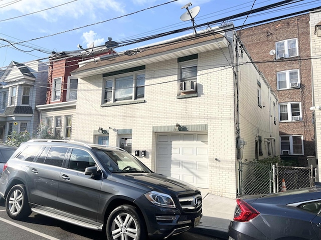 304 51st St, West New York, NJ 07093 - townhome / multi-family property featuring a garage, brick siding, and cooling unit