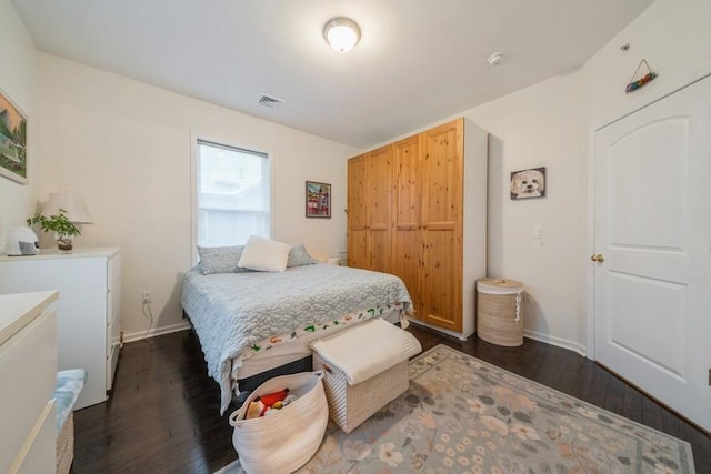 bedroom with dark hardwood / wood-style flooring