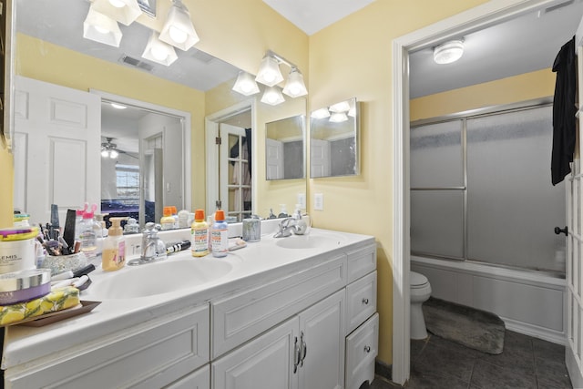 full bathroom featuring toilet, vanity, bath / shower combo with glass door, and tile patterned flooring