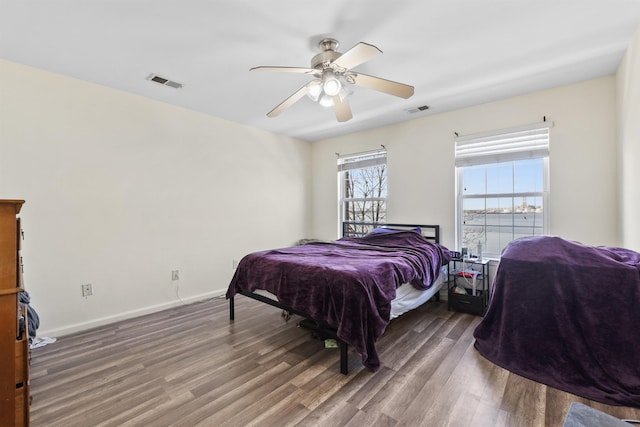 bedroom with ceiling fan and dark hardwood / wood-style flooring