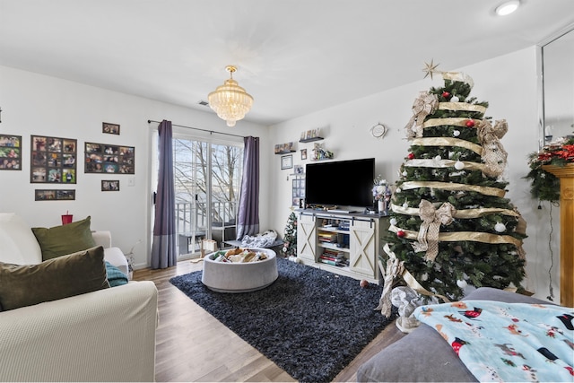 living room featuring a notable chandelier and wood-type flooring