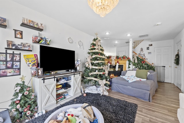 living room featuring a notable chandelier and light hardwood / wood-style floors