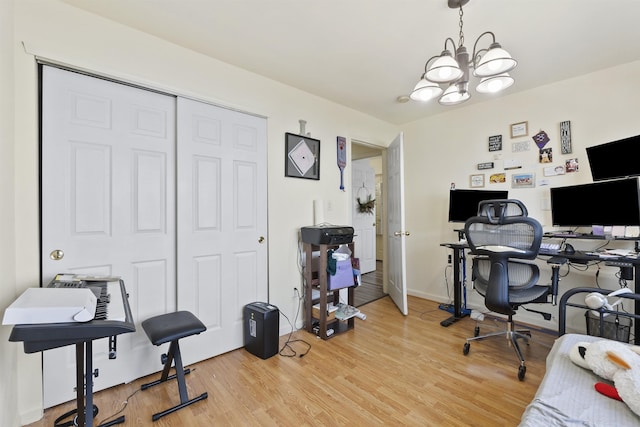 office space featuring wood-type flooring and a chandelier