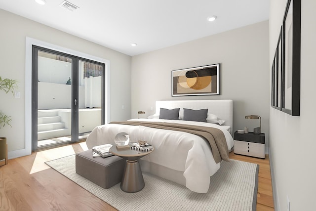 bedroom featuring light hardwood / wood-style floors and access to outside