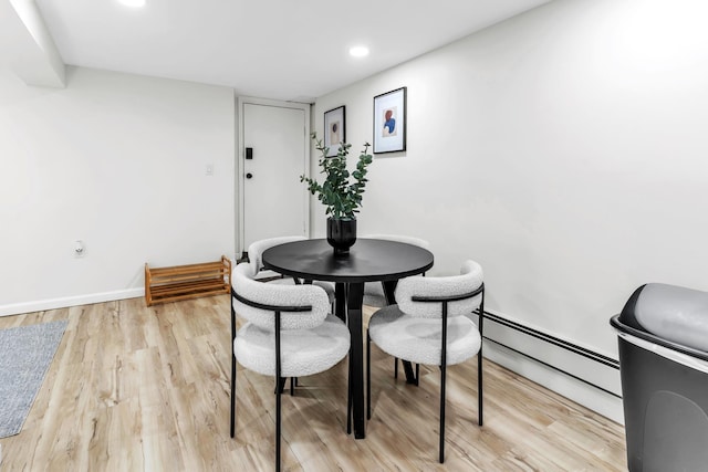 dining area with baseboard heating, recessed lighting, light wood-style flooring, and baseboards