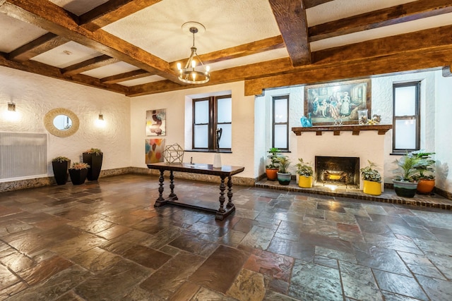 rec room with a notable chandelier and beamed ceiling