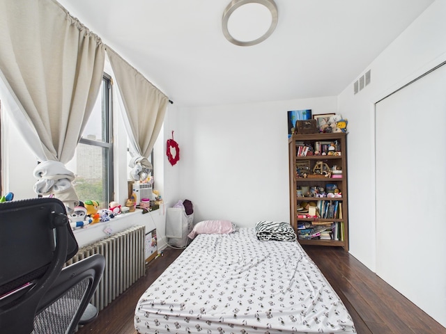 61 65th St Unit 10, West New York, NJ 07093 - bedroom featuring radiator heating unit and dark wood-type flooring