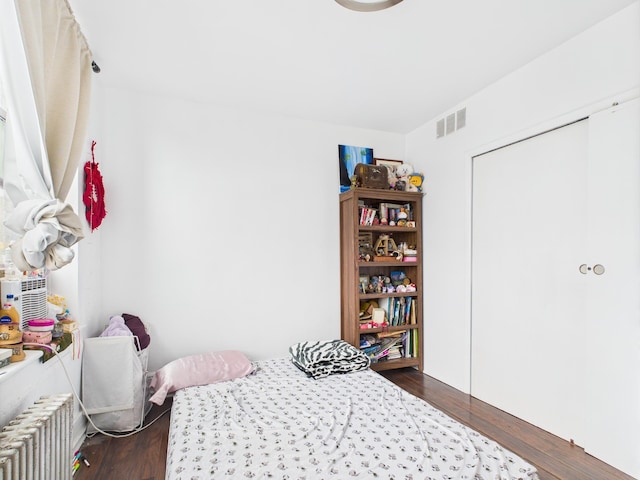 61 65th St Unit 10, West New York, NJ 07093 - bedroom featuring radiator heating unit and dark wood-style flooring