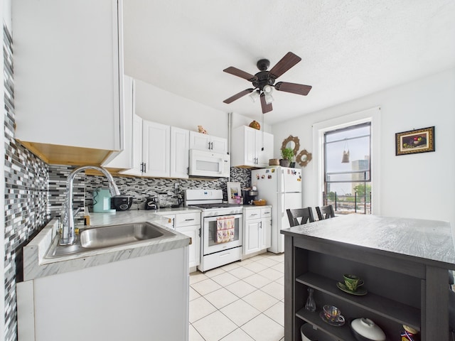 61 65th St Unit 10, West New York, NJ 07093 - kitchen with white appliances, backsplash, white cabinetry, a ceiling fan, and light countertops