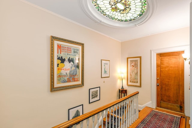 hallway featuring hardwood / wood-style floors and crown molding