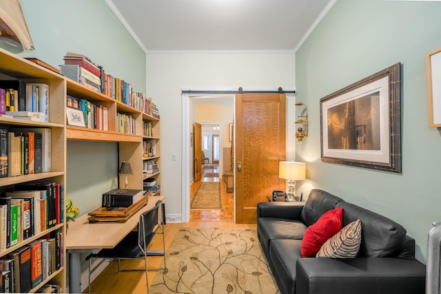 office area featuring ornamental molding, light hardwood / wood-style floors, and a barn door