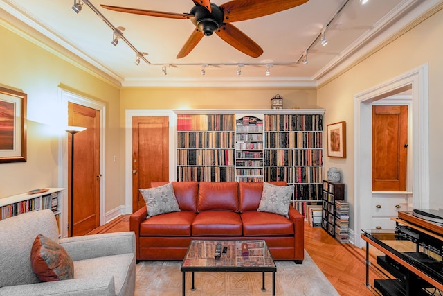 living room with crown molding, ceiling fan, rail lighting, and light hardwood / wood-style floors