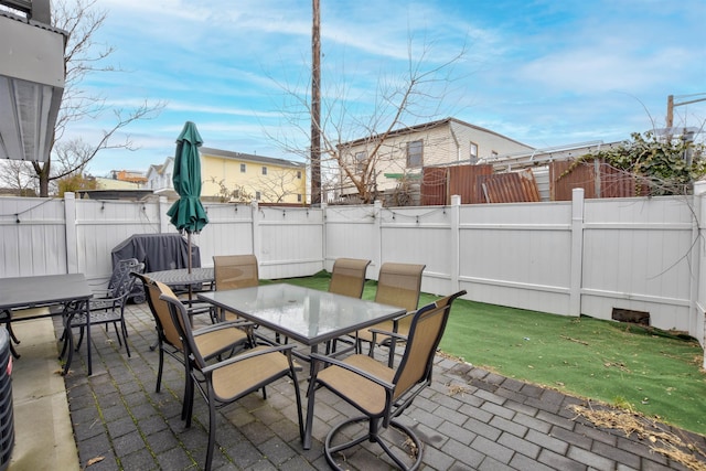 view of patio with a fenced backyard and outdoor dining area