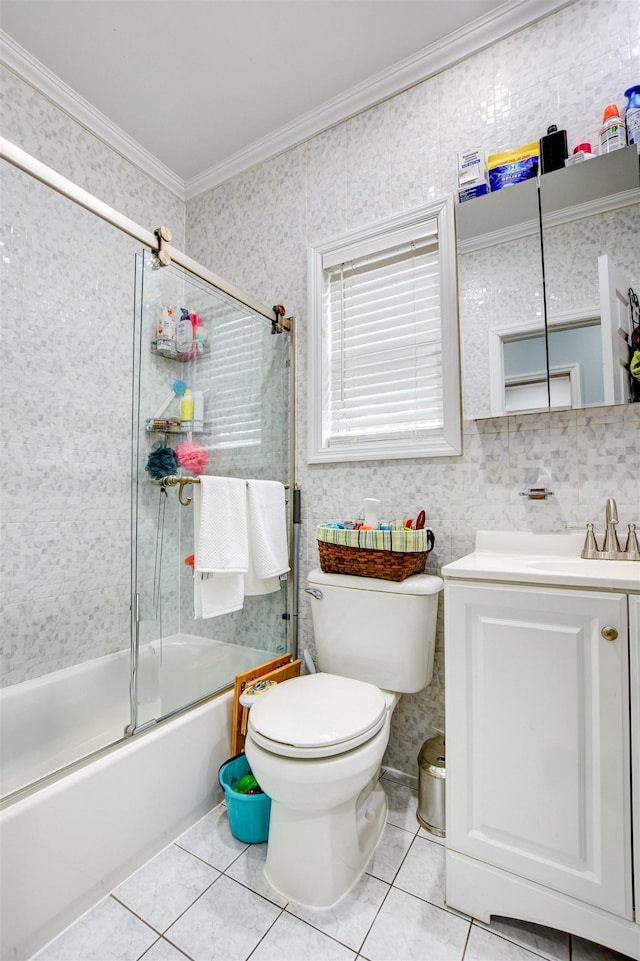 full bathroom with tile patterned floors, crown molding, toilet, and bath / shower combo with glass door
