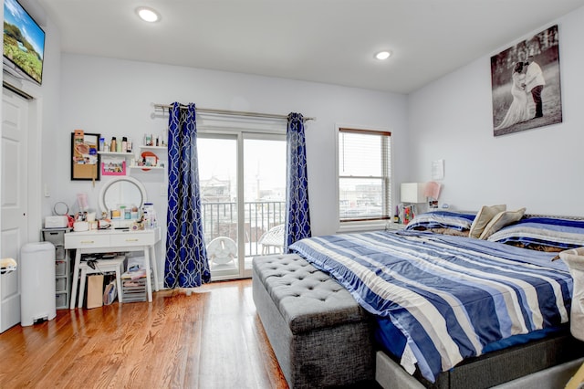bedroom featuring access to exterior, light wood-style floors, and recessed lighting