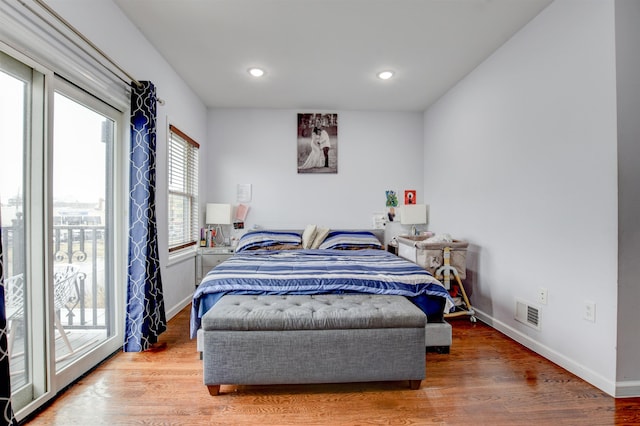 bedroom featuring recessed lighting, baseboards, access to outside, visible vents, and wood finished floors