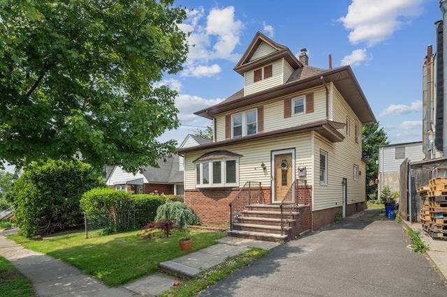 577 New Jersey Ave, Lyndhurst, NJ 07071 - american foursquare style home with a front lawn, a chimney, brick siding, and entry steps