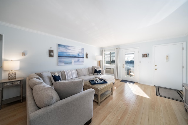 living room with light wood-type flooring and ornamental molding