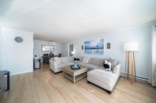 living room featuring baseboard heating, hardwood / wood-style flooring, ornamental molding, and a notable chandelier