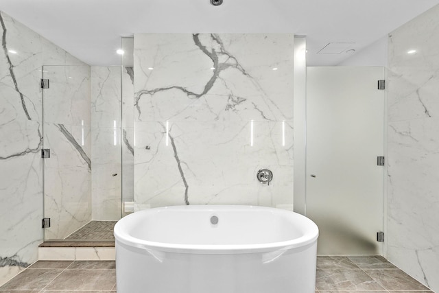 bathroom featuring separate shower and tub and tile walls