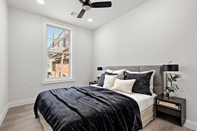 bedroom with light hardwood / wood-style flooring and ceiling fan