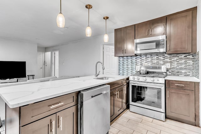 2200 Paterson Plank Rd Unit 23, North Bergen, NJ 07047 - kitchen with stainless steel appliances, a sink, tasteful backsplash, open floor plan, and decorative light fixtures