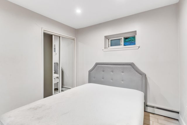 2200 Paterson Plank Rd Unit 23, North Bergen, NJ 07047 - bedroom featuring baseboard heating, light wood finished floors, a closet, and recessed lighting