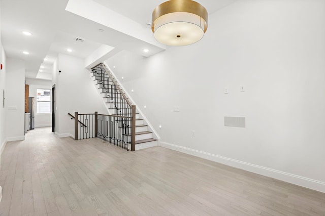 133 Clifton Pl Unit 3, Jersey City, NJ 07304 - unfurnished room featuring light wood finished floors, baseboards, recessed lighting, and stairway