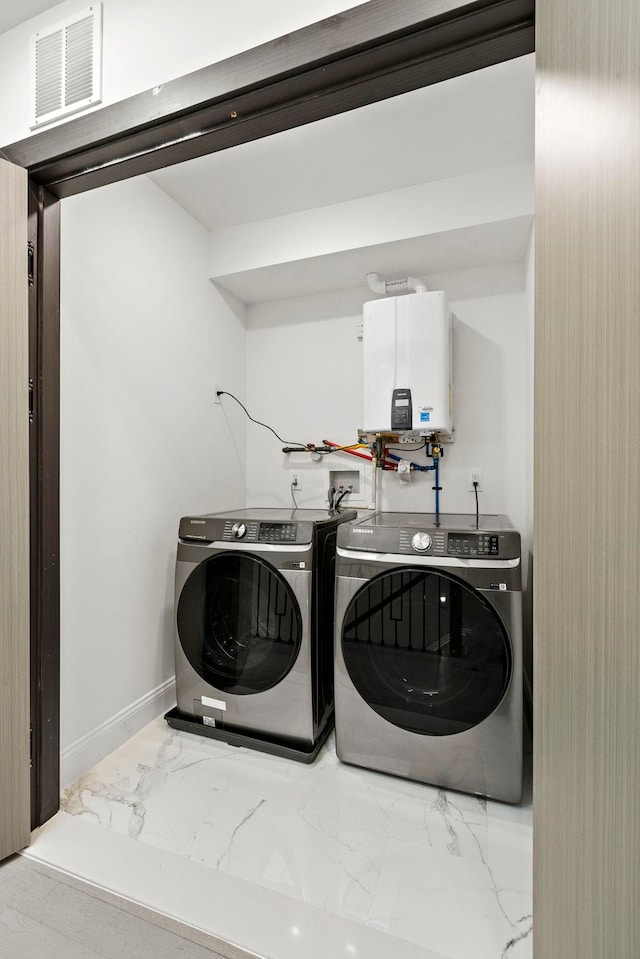 133 Clifton Pl Unit 3, Jersey City, NJ 07304 - laundry room with washer and clothes dryer, water heater, marble look tile flooring, and baseboards