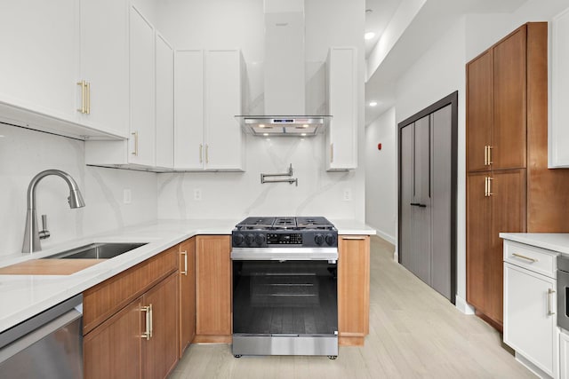 133 Clifton Pl Unit 3, Jersey City, NJ 07304 - kitchen with range with gas cooktop, wall chimney exhaust hood, stainless steel dishwasher, a sink, and light wood finished floors