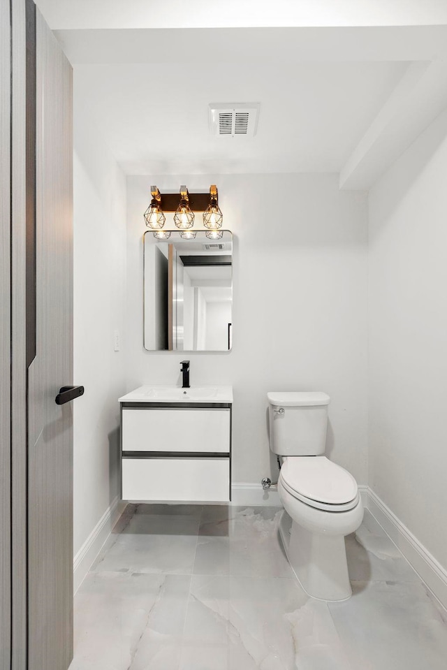 133 Clifton Pl Unit 3, Jersey City, NJ 07304 - half bath with baseboards, toilet, vanity, and marble look tiles