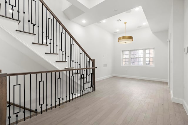 133 Clifton Pl Unit 3, Jersey City, NJ 07304 - stairway featuring wood finished floors, baseboards, recessed lighting, and a towering ceiling