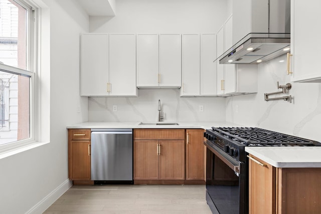 133 Clifton Pl Unit 3, Jersey City, NJ 07304 - kitchen with black gas stove, dishwasher, a sink, light countertops, and white cabinetry