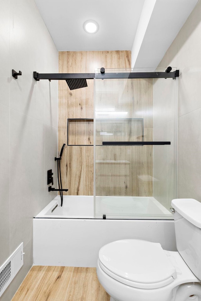 133 Clifton Pl Unit 3, Jersey City, NJ 07304 - full bathroom featuring combined bath / shower with glass door, toilet, and wood finished floors