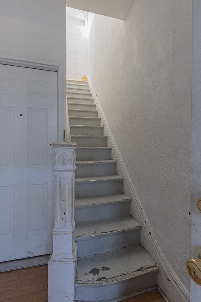 stairway featuring hardwood / wood-style flooring