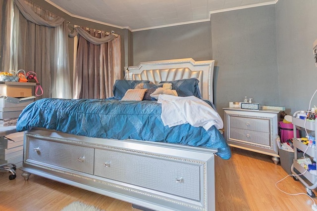 bedroom with crown molding and wood-type flooring