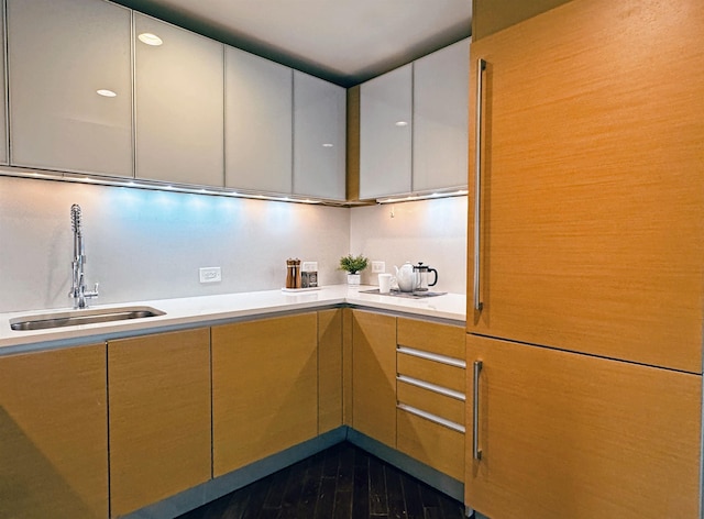 kitchen with modern cabinets, light countertops, and a sink