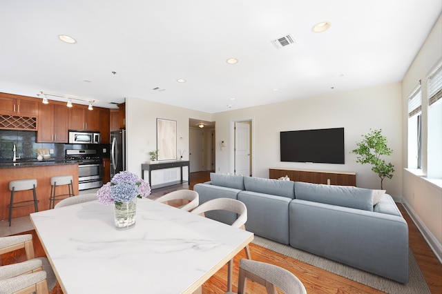 136 41st St Unit 103, Union City, NJ 07087 - dining room featuring wood finished floors, track lighting, recessed lighting, and baseboards
