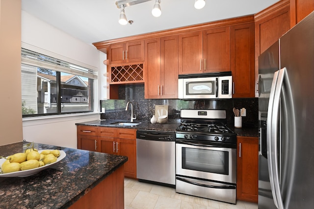 136 41st St Unit 103, Union City, NJ 07087 - kitchen with appliances with stainless steel finishes, a sink, decorative backsplash, and brown cabinets