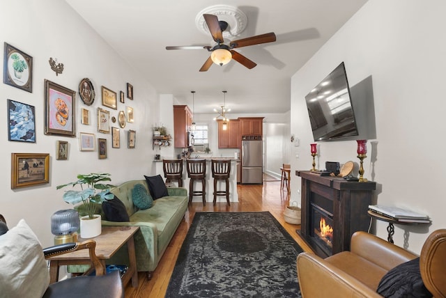 1114 Hudson St Unit 9, Hoboken, NJ 07030 - living room featuring ceiling fan, light wood-style floors, and a glass covered fireplace