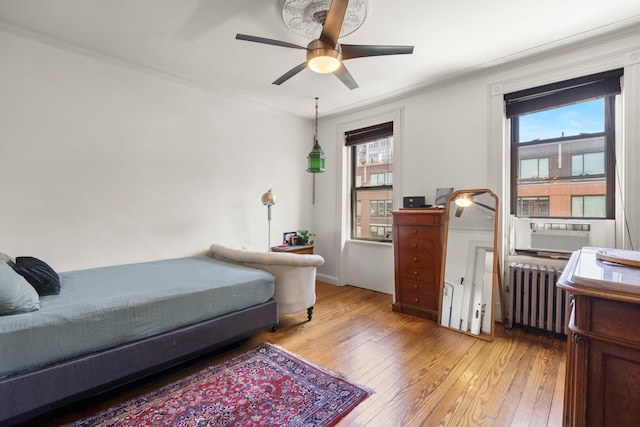 1114 Hudson St Unit 9, Hoboken, NJ 07030 - bedroom featuring radiator, light wood finished floors, crown molding, cooling unit, and ceiling fan
