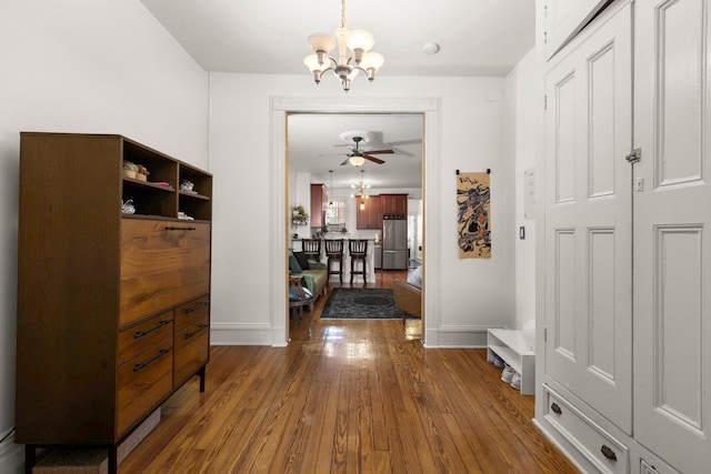 1114 Hudson St Unit 9, Hoboken, NJ 07030 - hall featuring a chandelier, wood-type flooring, and baseboards
