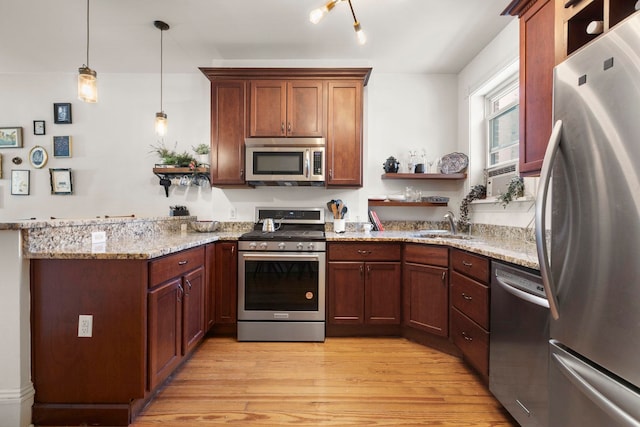 1114 Hudson St Unit 9, Hoboken, NJ 07030 - kitchen featuring appliances with stainless steel finishes, a peninsula, light wood finished floors, light stone countertops, and a sink