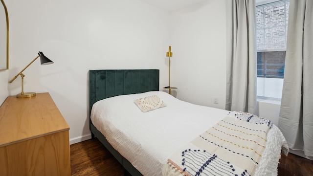 bedroom featuring dark hardwood / wood-style flooring