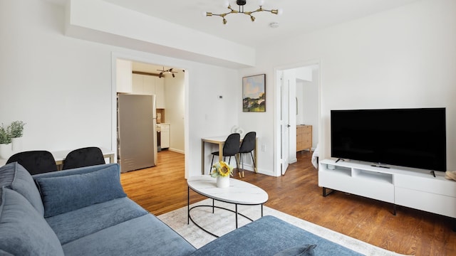 living room featuring a notable chandelier and hardwood / wood-style floors