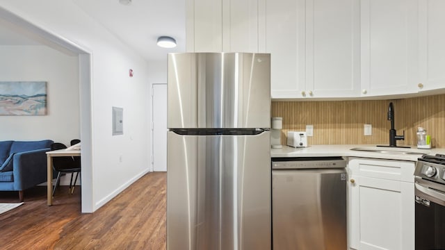 kitchen featuring white cabinets, stainless steel appliances, dark hardwood / wood-style flooring, and sink