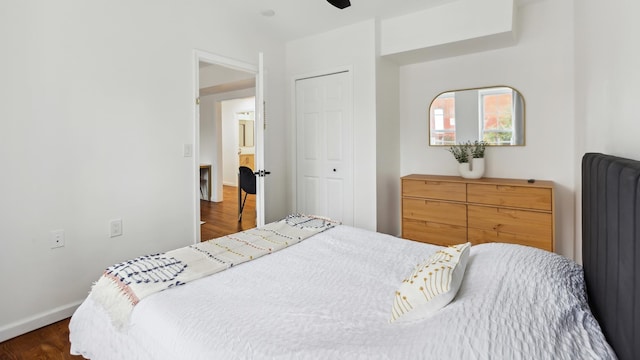 bedroom with radiator, a closet, ceiling fan, and dark wood-type flooring